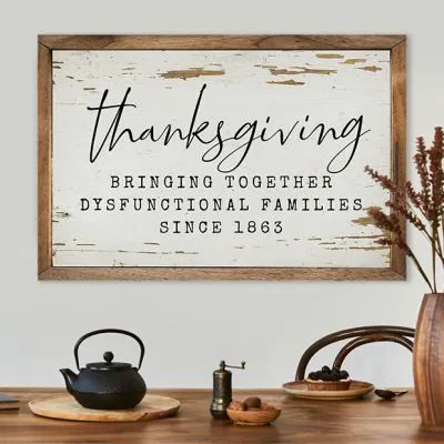 a wooden sign that says, thanksgiving bringing together disffuctional families since 1853