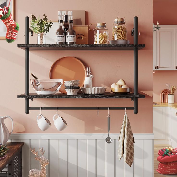 a kitchen with pink walls and shelves filled with dishes, utensils and cups