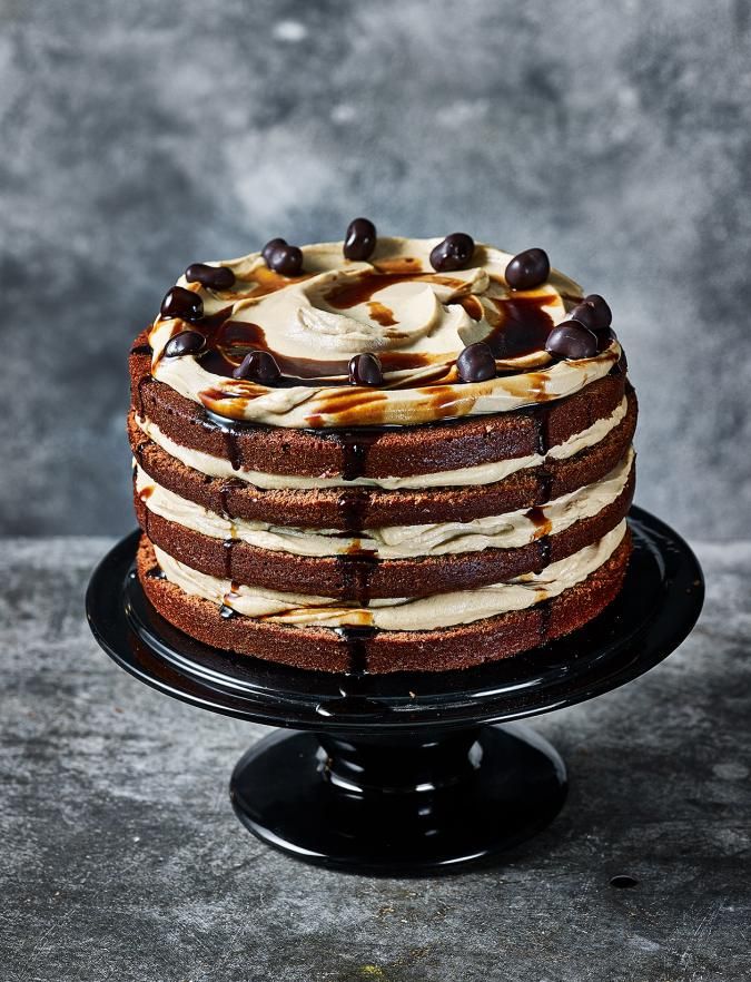 a chocolate cake with white frosting and caramel toppings