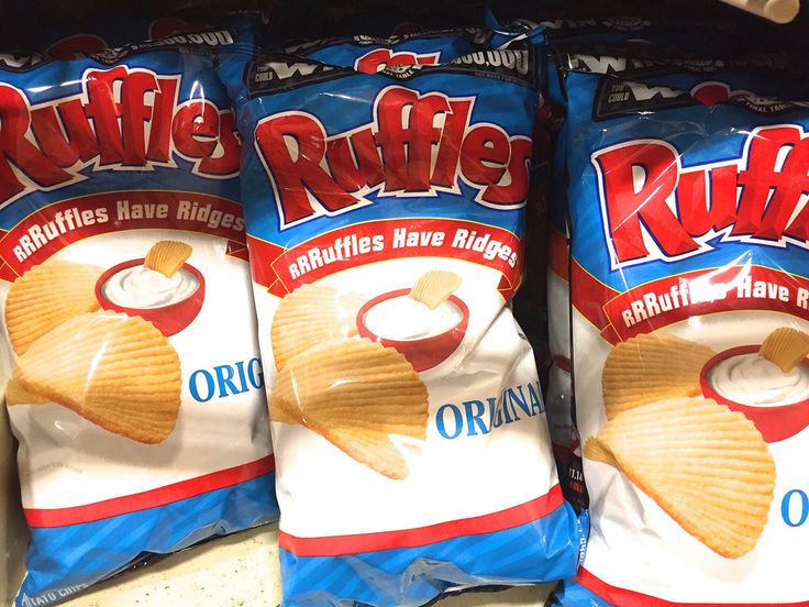 three bags of ruffles are sitting on the shelf