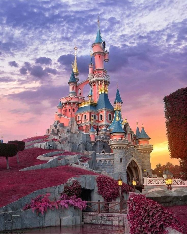 an image of a castle that is in the sky with flowers growing on it's sides