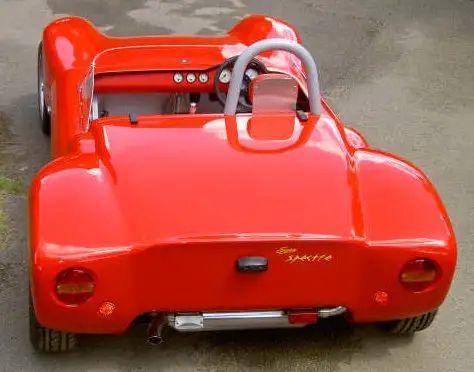 an orange toy car is parked on the street