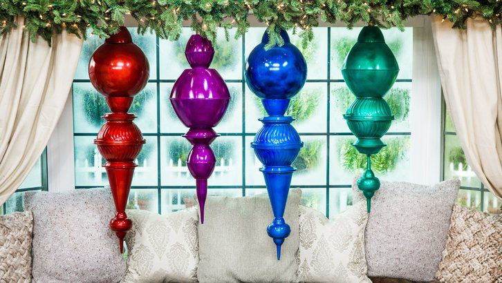 a group of colorful vases sitting on top of a couch