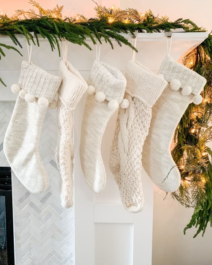 christmas stockings hanging from a mantel over a fireplace