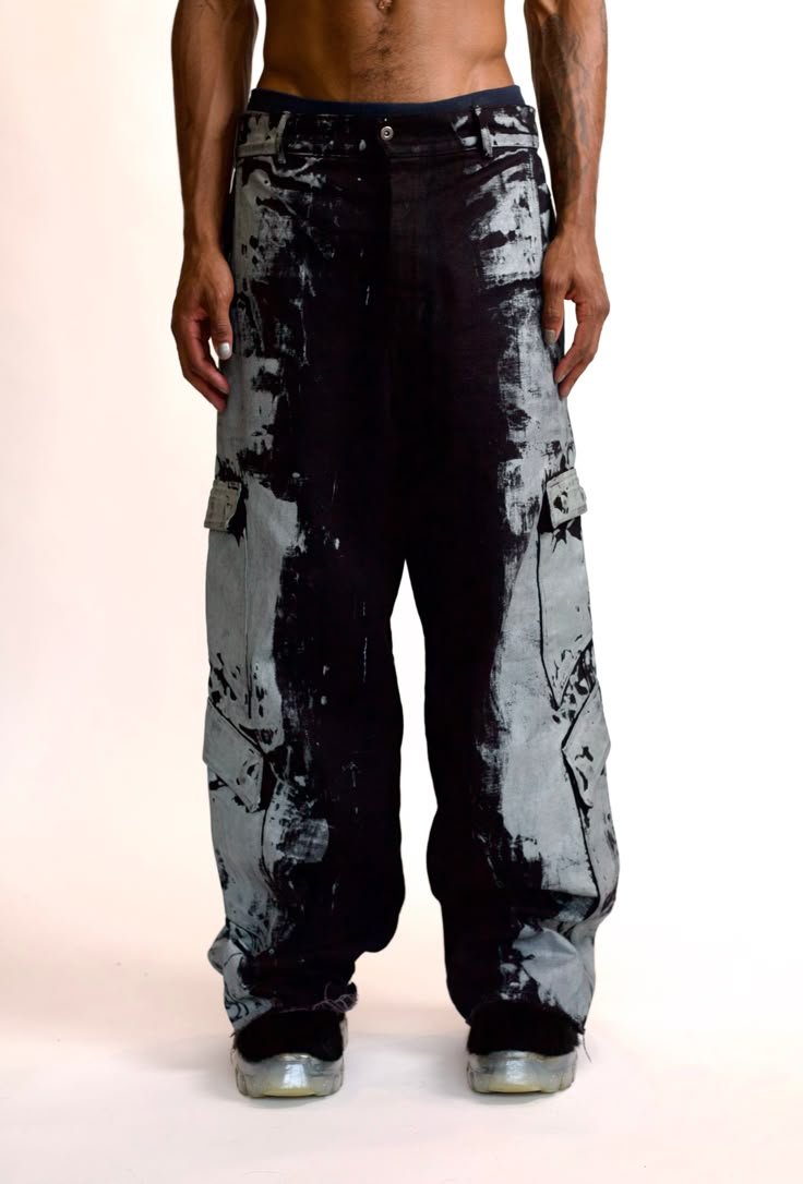 STERRE PEYTON JANUS DUST CARGO PANT PART OF THE NU SZN COLLECTION. THIS PANT IS A BAGGY FIT AND FEATURES A TRADITIONAL BUTTON FLY. THESE PANTS FEATURE EIGHT POCKETS WITH THE REAR POCKETS FEATURING A BUTTON HOLE CLOSURE AND THE SIDE POCKETS FEATURE SNAP CLOSURE FLAPS. THIS PANT FEATURES THE SIGNATURE DUST DESIGN ON THE LEFT AND RIGHT SIDES OF THE PANTS. THIS PANT IS MADE OF A HEAVY DENIM FOR FIT AND DURABILITY. COLORS: Black, Pearl This garment is a hand painted piece. Paint marks are to be expec Punk Uniform, Cool Pants Outfit, Painting Pants, Pants Outfit Men, Casual Pants Style, Baggy Cargo Pants, Black Y2k, Button Hole, Model Outfits