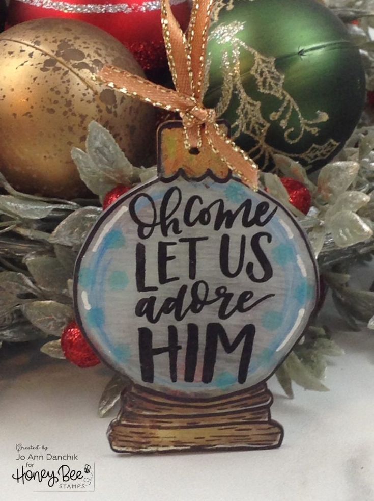 a christmas ornament that says,'come let us adore him '