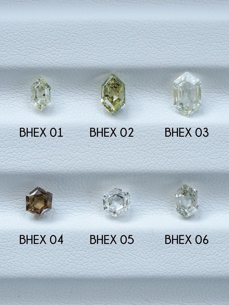 an assortment of different colored diamonds on display