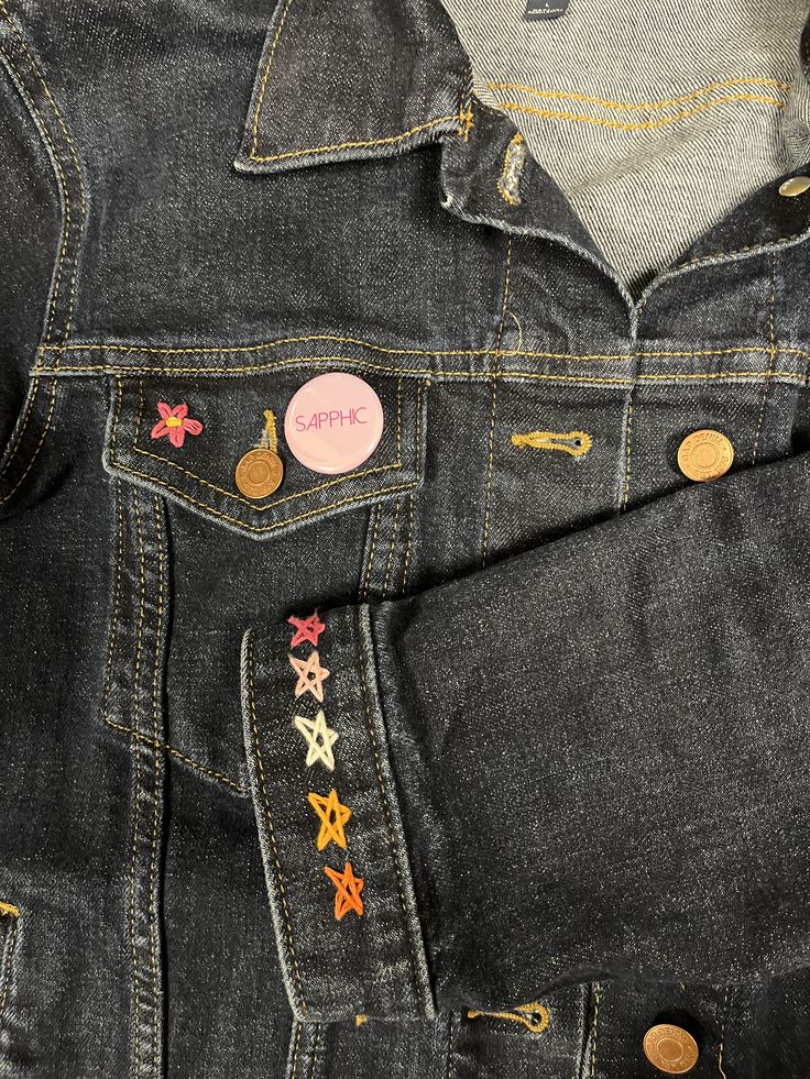 a pair of jeans with colorful stars on the back and one button in the pocket