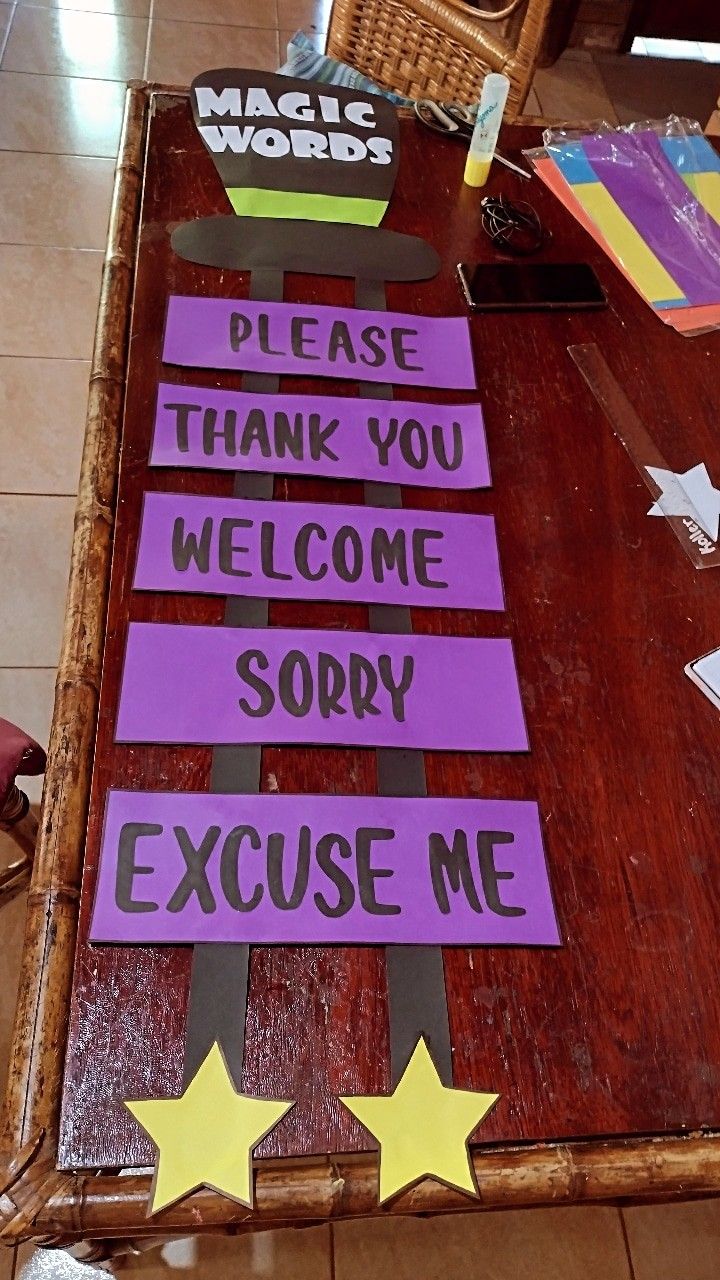 a wooden table topped with purple and yellow signs