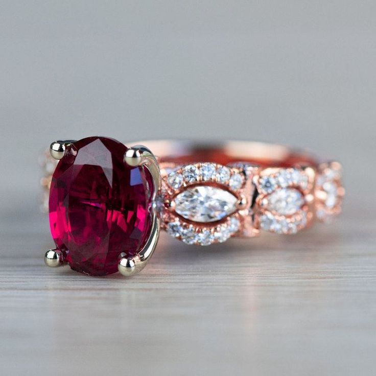 Chathem Ruby Engagement Ring In Rose Gold Luxury Rose Gold Ruby Ring With Diamond Cut, Engagement Rings With Ruby Accents, Luxury Oval Diamond Ring With Lab-created Ruby, Exquisite Oval Ruby Ring Gia Certified, Elegant Gia Certified Oval Ruby Ring, Luxury Emerald Cut Lab-created Ruby Rings, Luxury Red Marquise Cut Jewelry, Formal Oval Lab-created Ruby Jewelry For Weddings, Oval Lab-created Ruby Fine Jewelry For Wedding