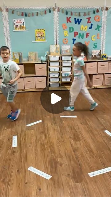 two young children are running around in a classroom