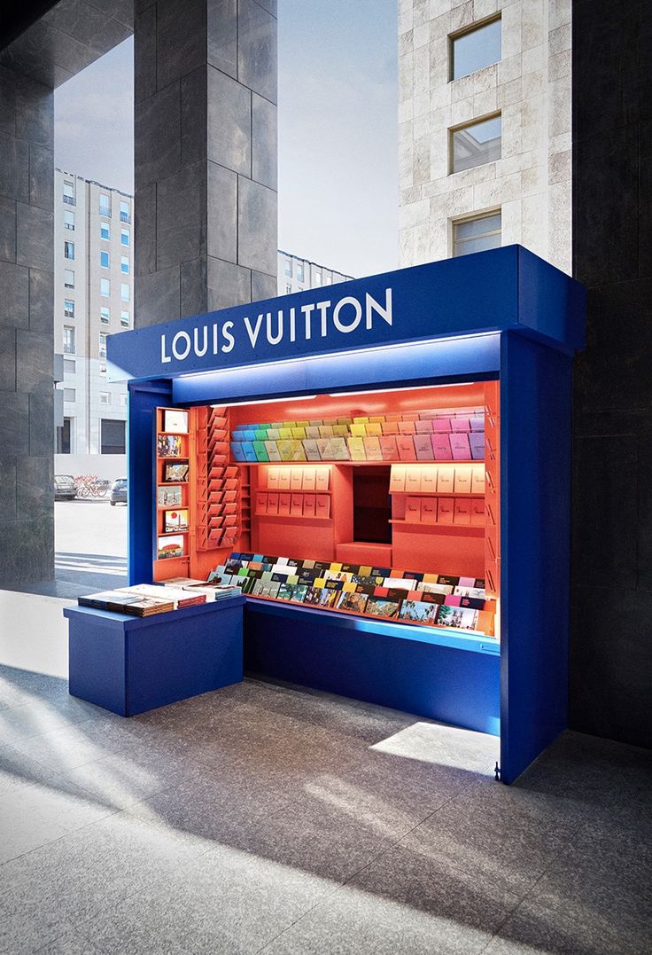 the louis vuitton book stand is blue and has many books in its display case