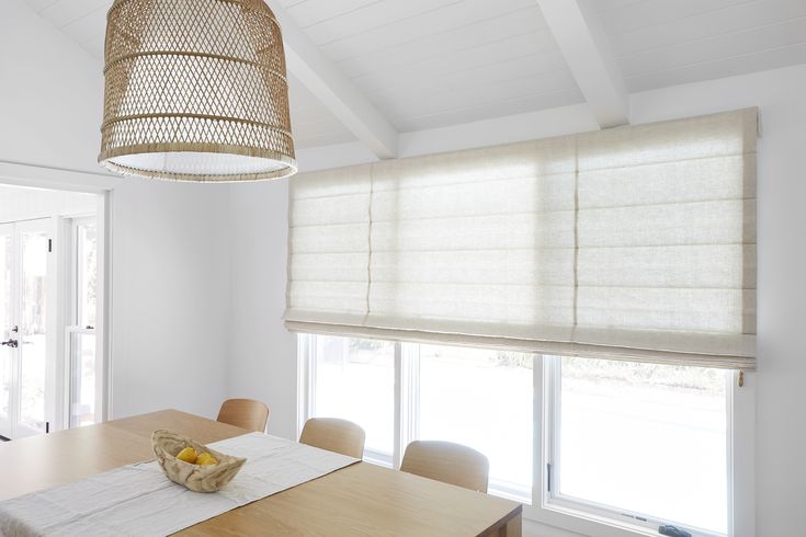 a dining room table with a basket hanging from the ceiling