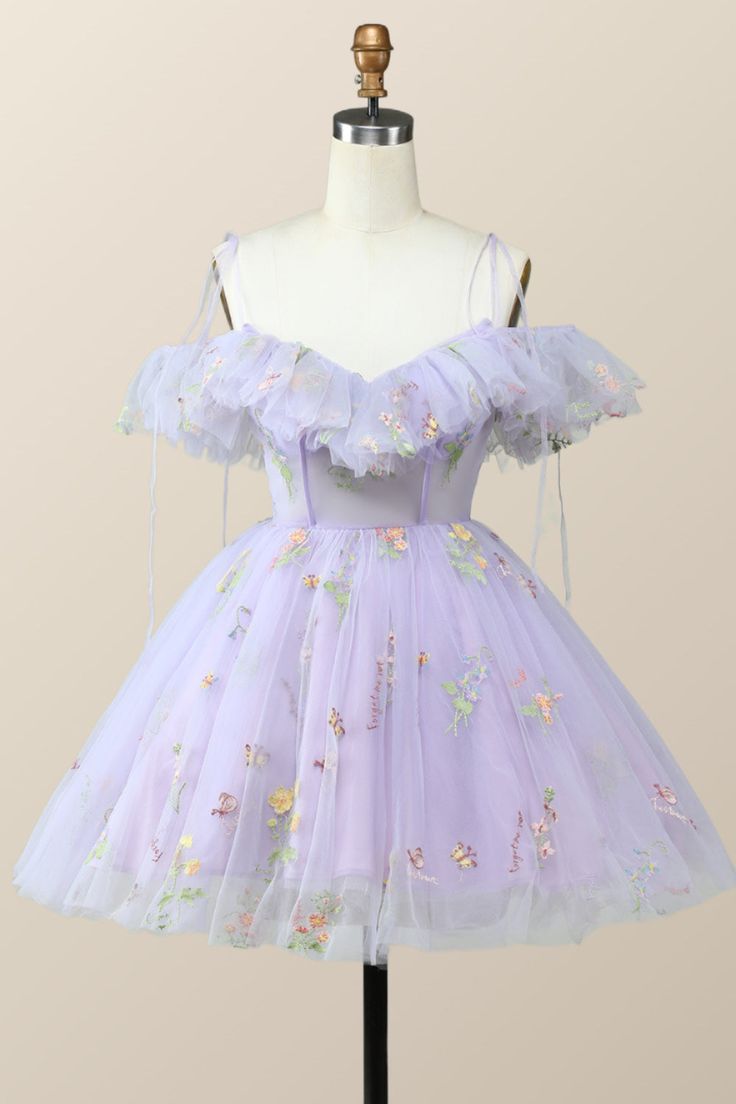 A vision of exquisite beauty, this lavender dress is constructed from tulle that shapes an A-line silhouette and cascades with delicate spaghetti straps, ruffled neck, and a secure zip-up fastening at the back. Light Purple Aesthetic Clothes, Purple Fairy Dress Short, Tangled Inspired Hoco Dress, Tangled Themed Hoco Dress, Lavender Homecoming Dress Short, Tangled Homecoming Dress, Tulle Hoco Dress, Light Purple Homecoming Dress, Lavender Hoco Dress