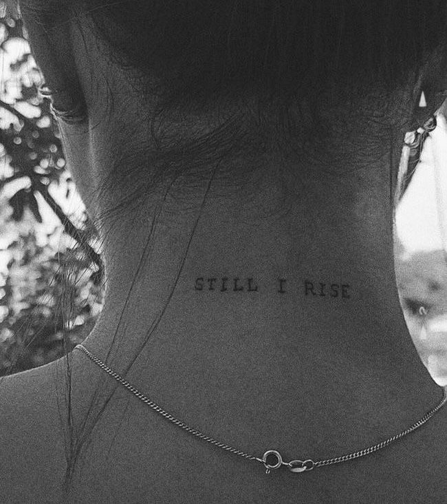 a woman with a tattoo on her neck saying still i rise