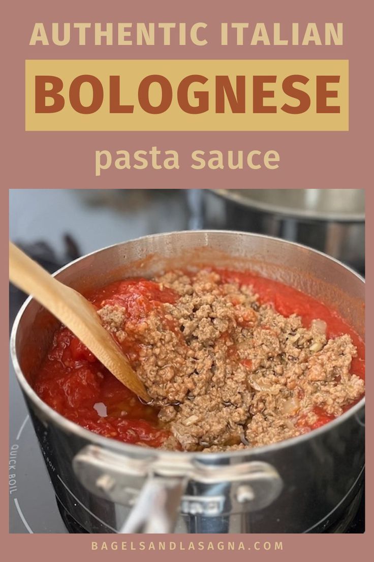 a pot filled with pasta sauce on top of a stove next to a wooden spoon