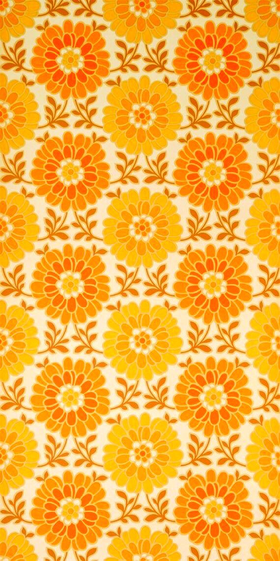 an orange and yellow flower pattern on fabric