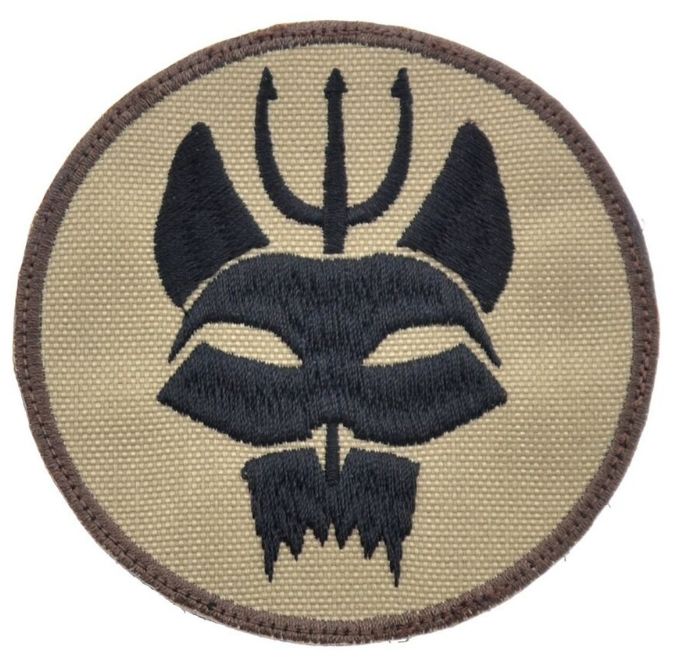 a patch with an image of a demon's head and two horns on it