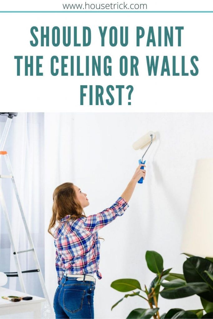 a woman is painting the ceiling or walls in her living room with text overlay that reads should you paint the ceiling or walls first?