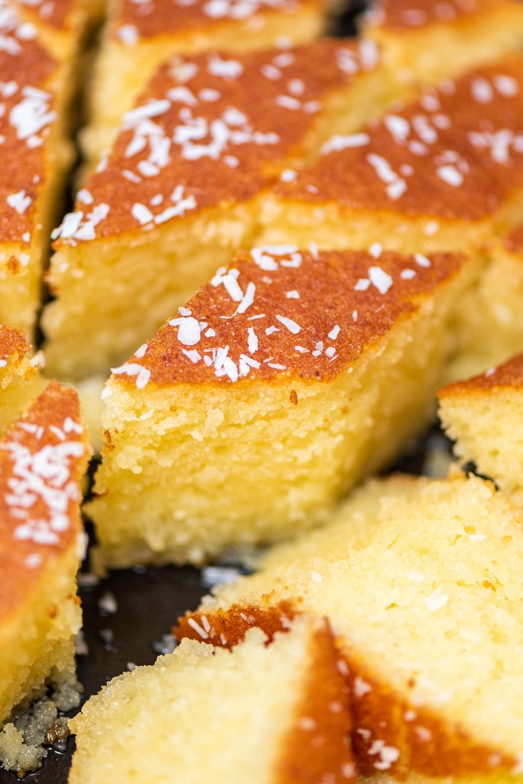 slices of cake sitting on top of a pan covered in sugar