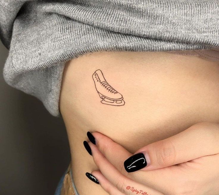 a woman's stomach with a tattoo on it