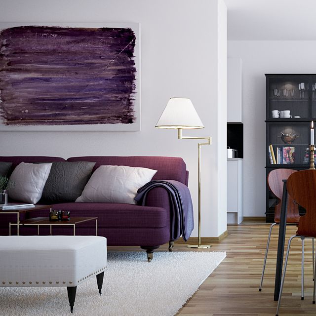 a living room filled with furniture and a painting on the wall