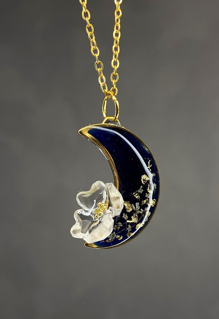 Moon with natural flower form epoxied risen This pendant was handcrafted in resin. Color risen: deep blue near to black Available 2 color: cold and silver The components are in steel (nickel free) Terri Celestial Resin Jewelry As Gift, Celestial Resin Jewelry For Gifts, Celestial Resin Jewelry As A Gift, Celestial Style Resin Jewelry For Gifts, Black Pressed Flowers Jewelry Gift, Black Moon-shaped Jewelry For Gift, Black Half Moon Jewelry For Gift, Vintage Concert T Shirts, Flower Moon