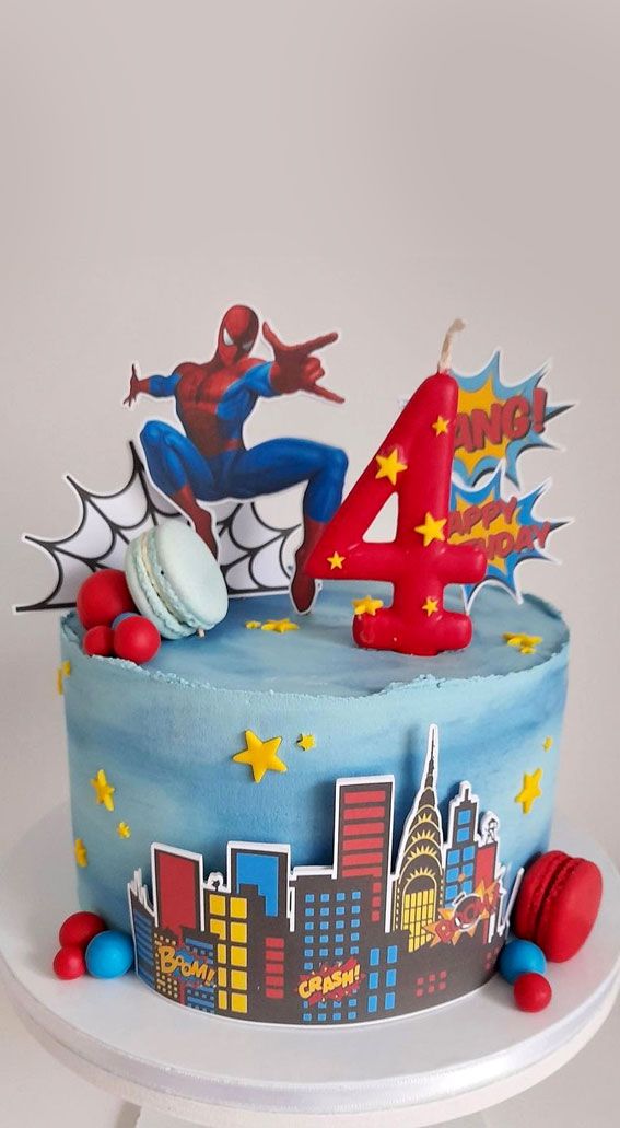 a spiderman birthday cake with the number four on it's top and decorations