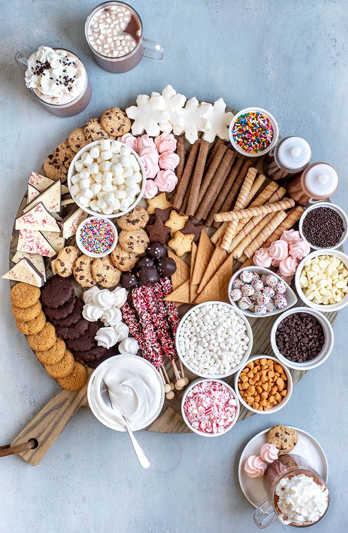 a platter filled with lots of different kinds of snacks and desserts on top of each other