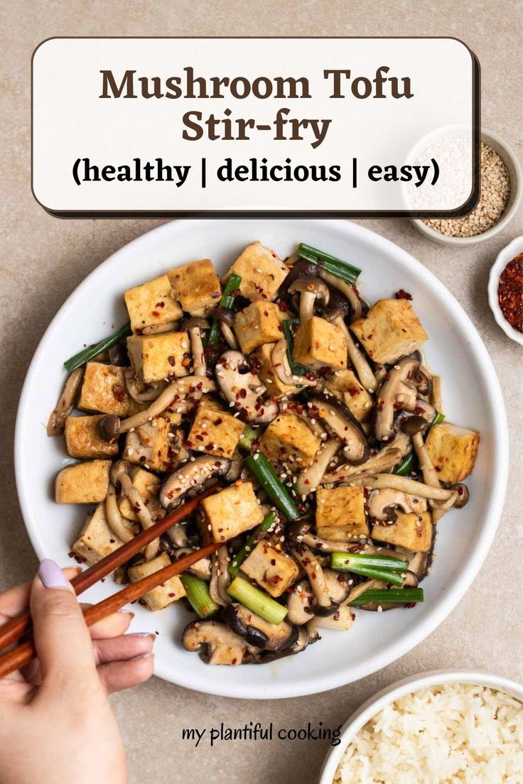 mushroom tofu stir - fry in a white bowl with chopsticks on the side