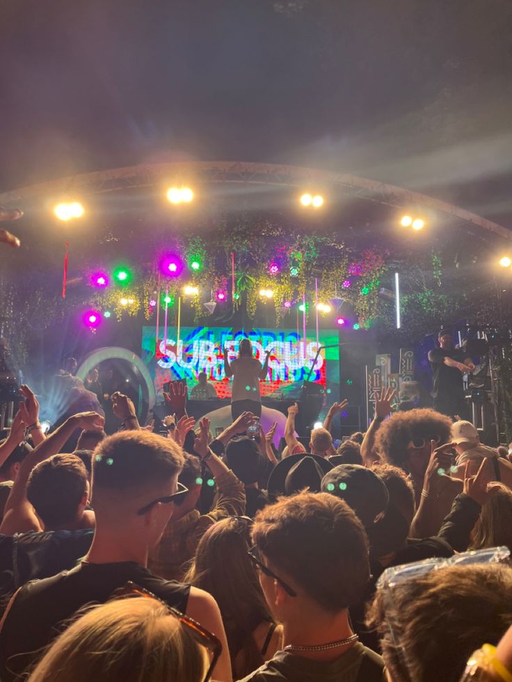 a crowd of people standing on top of a stage