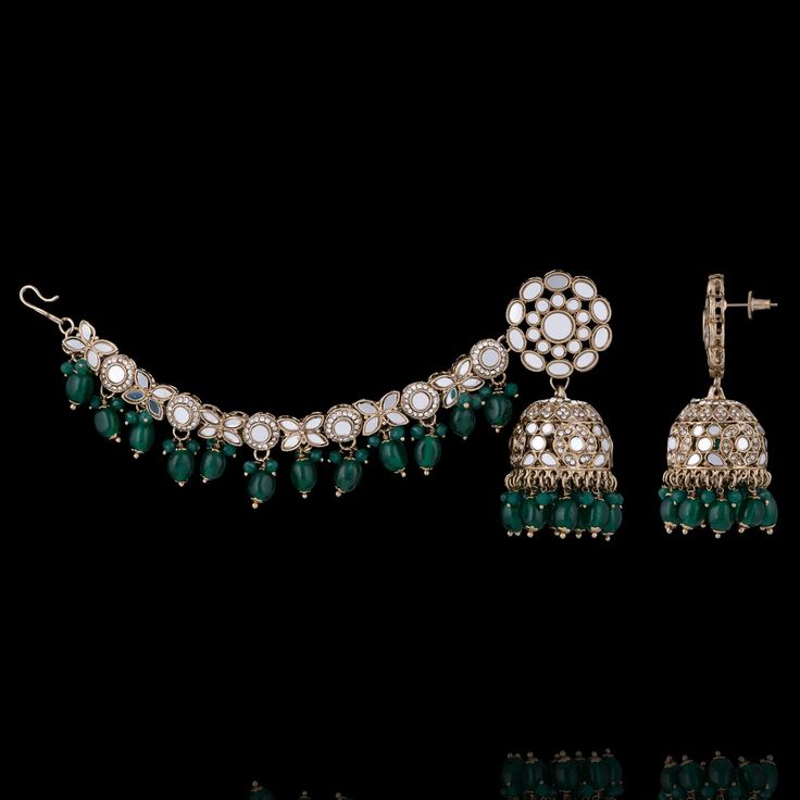 Add a touch of regal splendor to your look with our must-have Vishali Set! A perfect blend of elegance and traditional charm, this earring and maang teekah set is a true testament to the craftsmanship of our skilled artisans. Studded with mirror stones and pearls, this set is designed to complement any ensemble and make a statement wherever you go. Approximate earrings length is 3". Gold-plated on high-quality brass as base metal. Vishali Set (Emerald) is in-stock & ready-to-ship. *Please Note: Traditional Jewelry Sets With Matching Earrings For Diwali, Traditional Diwali Jewelry Sets With Matching Earrings, Bollywood Ceremonial Jewelry With Matching Earrings, Bollywood Style Ceremonial Jewelry With Matching Earrings, Elegant Ceremonial Jewelry With Mirror Work, Ceremonial Kundan Tilla Earrings, Kundan Jewelry Sets With Latkans For Eid, Traditional Jewelry Sets With Matching Earrings, Elegant Festive Jhumkas With Mirror Work