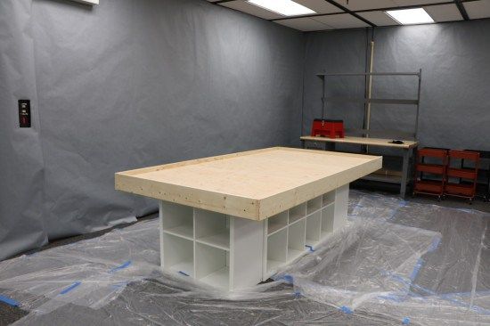 a room that is being remodeled with plastic covering the floor and table in front of it