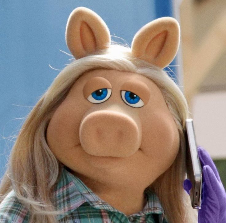 the miss piggy doll is talking on her cell phone