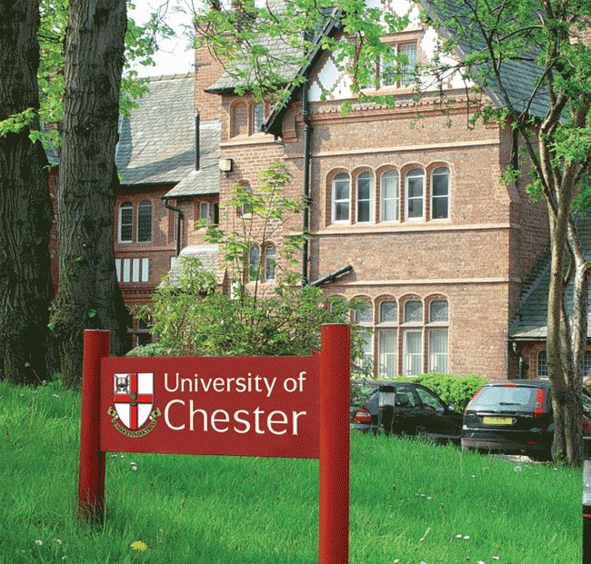 the university of chester sign is in front of a large brick building with cars parked outside