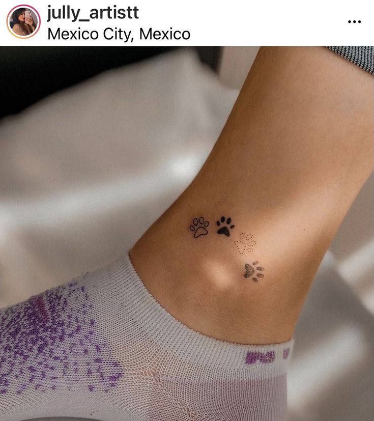 a person with a small tattoo on their ankle and paw prints on the ankle area