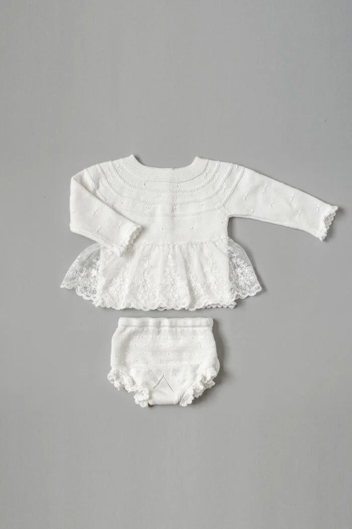 Introducing our Vintage Gorgeous Knitted Dress 2-Piece Set in a timeless Off-White hue! The knitted top, adorned with an embroidered lace skirt, boasts an enchanting vintage-inspired charm. Delicate scallops grace the edges of the long sleeves and the bottom of the top, while the knitted bloomer echoes this elegance with its own scalloped details. Designed for little ones from 0 months to 2 years, this ensemble captures the essence of vintage beauty with a modern twist. The off-white color adds White Lace Trim Sets For Daywear, Fitted Lace Trim Sets For Daywear, Cream Lace Fitted Sets, Fitted Cream Lace Sets, Fitted White Sets With Lace Trim, White Fitted Sets With Lace Trim, Fitted White Set With Lace Trim, Fitted Vintage Sets With Lace Trim, Fitted Vintage Set With Lace Trim