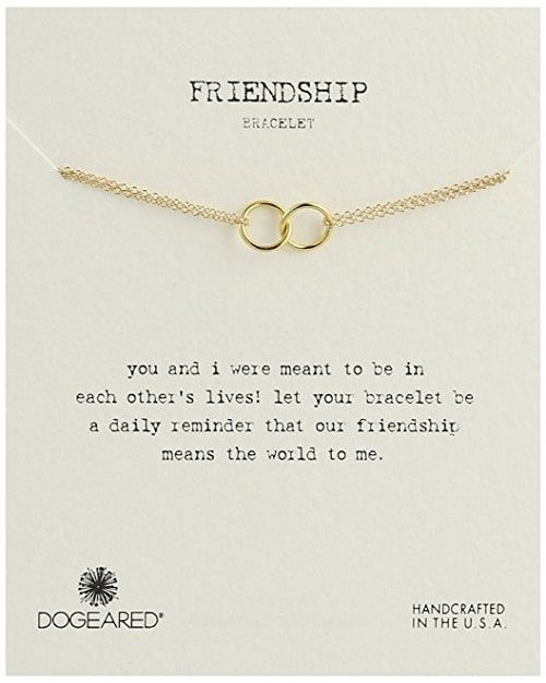 a gold necklace with two intertwined rings on it's chain that reads, friendship