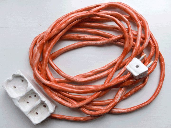 an orange cord with two white outlets attached to it