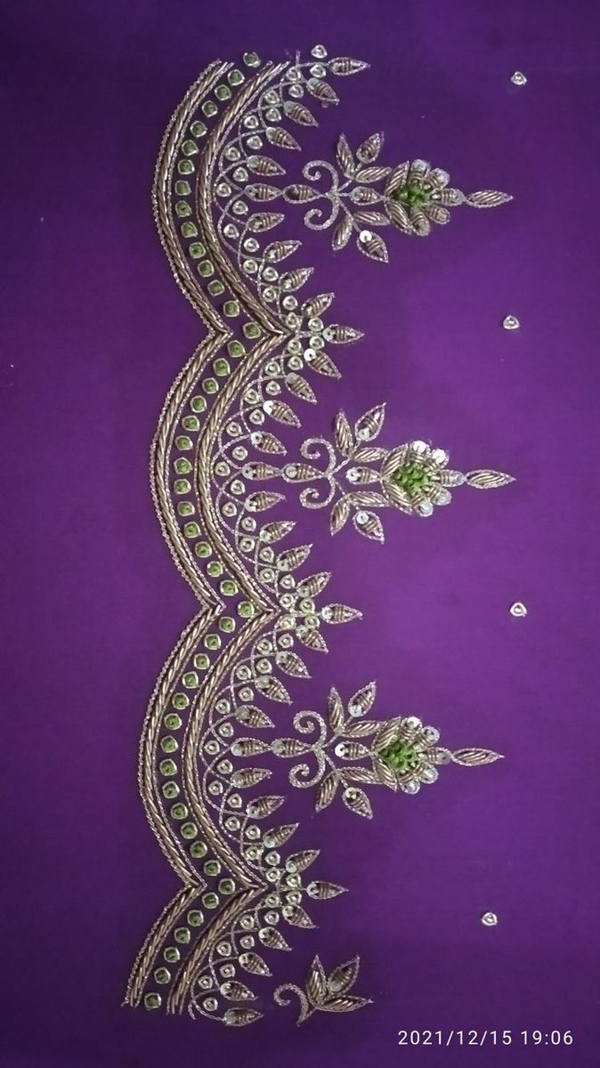 an embroidered purple fabric with green and white flowers on the side, along with sequins