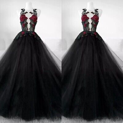 the dress is black and has red flowers on it