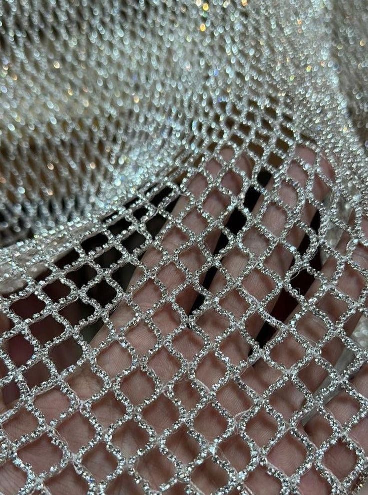 Our Crystal Lattice or Crystal Chain fabric is hand-beaded by skilled artisans in India using high-quality glass crystal chains. This luxurious, one-of-a-kind fabric can be customized in any color to meet your design needs. Perfect for couture gowns, bridal wear, and high-end fashion projects. Key Details: Sold By: Yard Customization: Available in any color Hand-Beaded: Yes, by artisans in India Materials: Glass crystal chain Perfect for: Couture, bridal, luxury fashion Minimum Order: 1 yard Pro Outfit Verano, Crystal Lattice, Rhinestone Fabric, Embellished Fabric, Fashion Vocabulary, Net Fabric, Fabric Beads, Crystal Chain, Embroidery Fabric