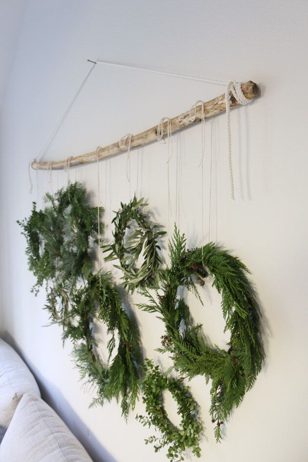 two wreaths hanging on the wall next to a bed