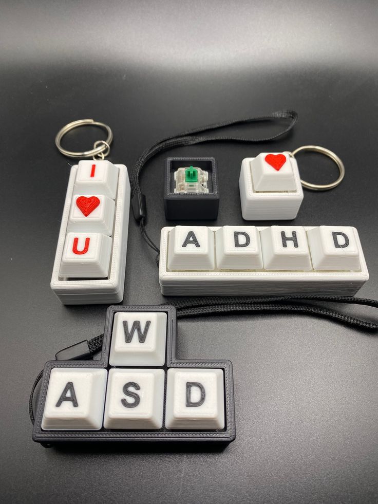 some type of keychain with letters and hearts on them