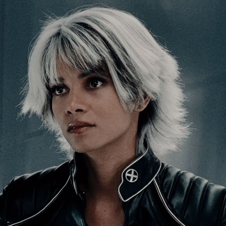 a woman with white hair wearing a black leather jacket