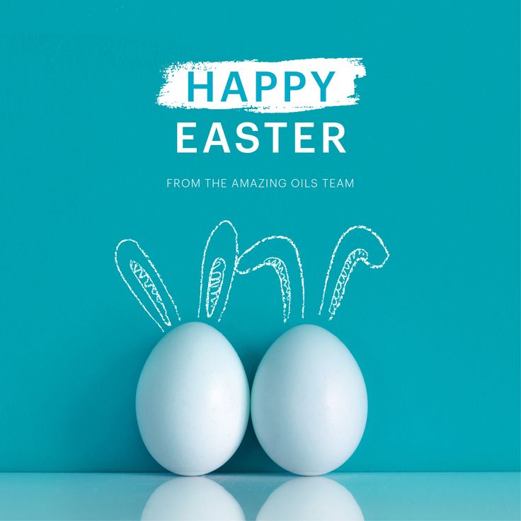 two eggs sitting on top of each other in front of a blue background with the words happy easter from the amazing oils team