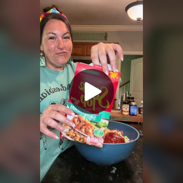 a woman pouring ketchup into a bowl filled with food