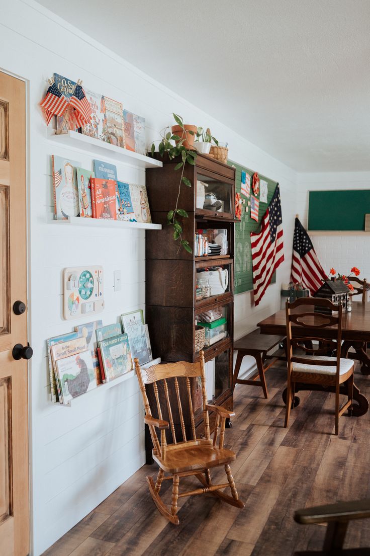 a room filled with wooden furniture and american flags on the wall