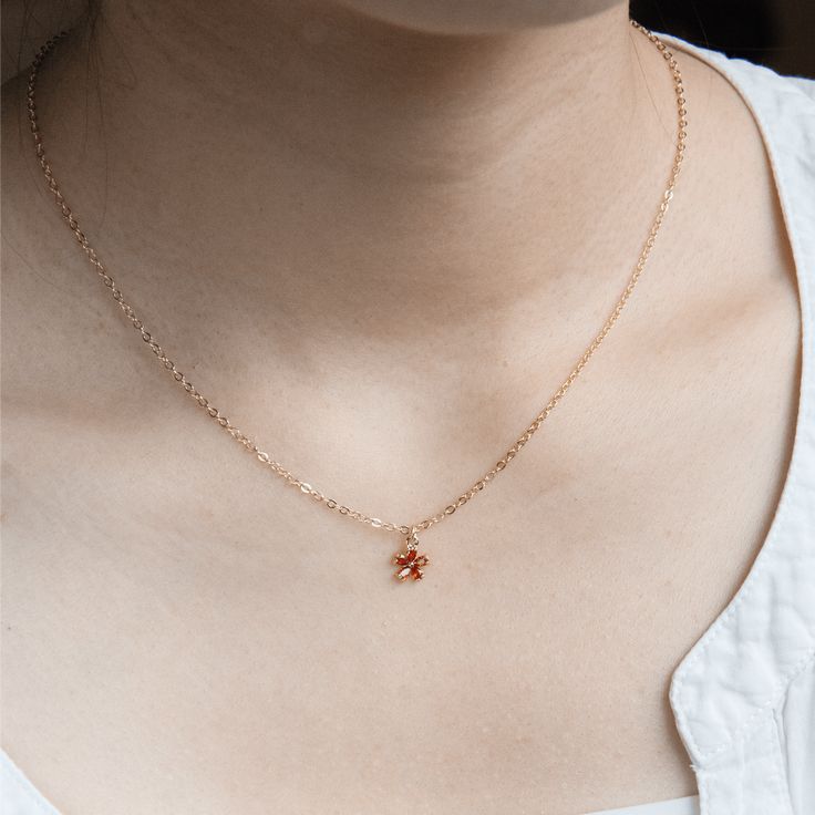 Sunlit Blossom Necklace features a sweet orangey red crystal flower pendant. Picture the intense glow of a sunset, where the sun bathes the sky in a rich combination of fiery oranges and deep reds. The color of this crystal pendant shows love and passion, making it great for any time you want to feel special. • 14K Gold-Filled. • Faceted red crystal. Dainty Red Flower Pendant Necklace, Orange Pendant Necklace With Birthstone, Orange Birthstone Pendant Necklace, Orange Birthstone Necklace As Gift, Orange Birthstone Necklace Gift, Orange Flower Pendant Jewelry For Gift, Orange Flower Pendant Jewelry Gift, Orange Flower Pendant Necklace For Gift, Orange Flower Pendant Necklace Gift