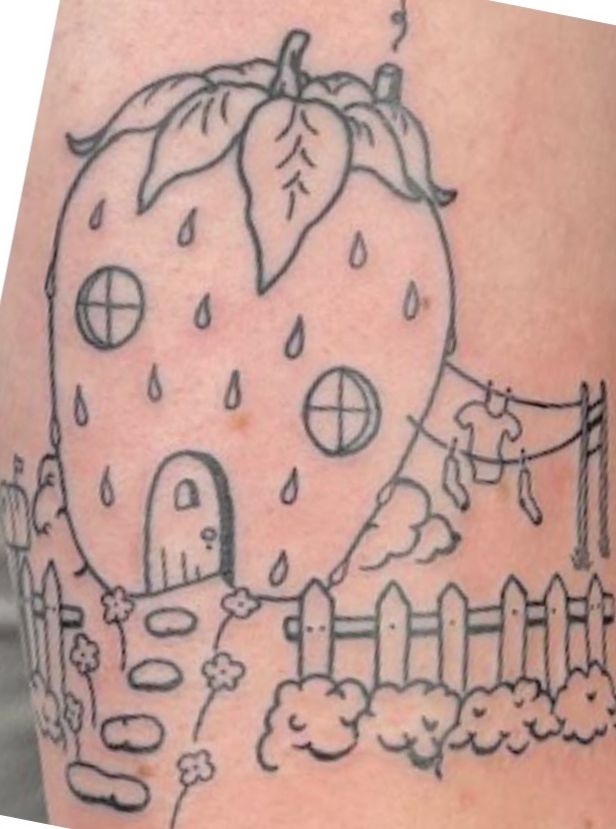 a drawing of a strawberry house on the side of a woman's leg with raindrops